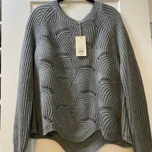 Grey woven sweater.